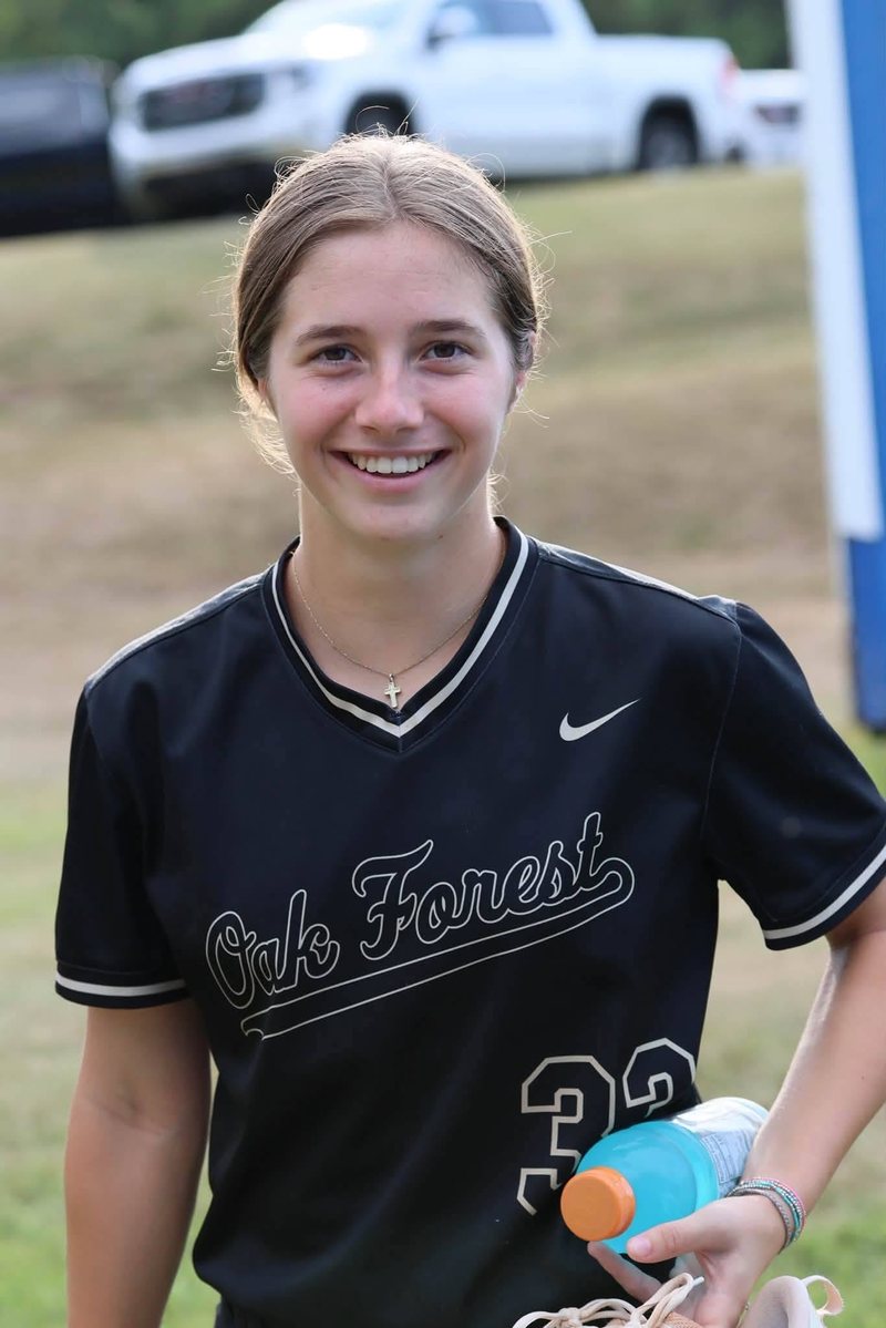 Kali Hinson smiling in her Oak Forest softball jersey
