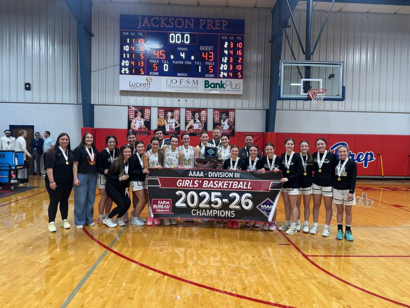 Oak Forest Academy girls basketball team celebrating their 2025-26 4A Division III state championship at Jackson Prep
