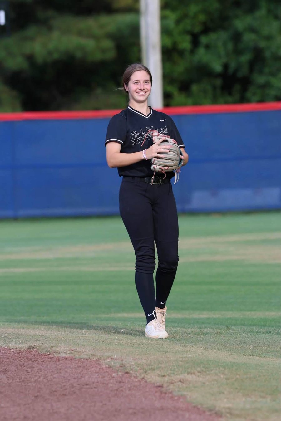 Kali Hinson smiling in the infield